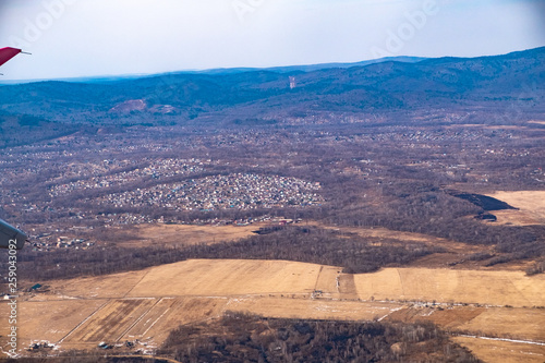 Fototapeta Naklejka Na Ścianę i Meble -  View from the plane on the outskirts of the city of Artem. Primorsky Krai.
