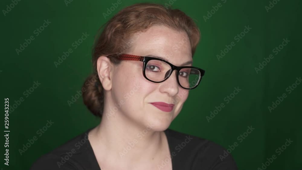 Smart Positive Beautiful Woman Wearing Glasses and Smiles on Green Background , Smart Positive Beautiful Woman Wearing Glasses and Smiles on Green Background ,