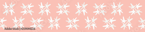 Beach sea star seamless pattern. Starfish form flower shapes repeating on a blush pink background. Great for wedding, spa or resort stationery, textiles, gift wrapping ribbon or product packaging.
