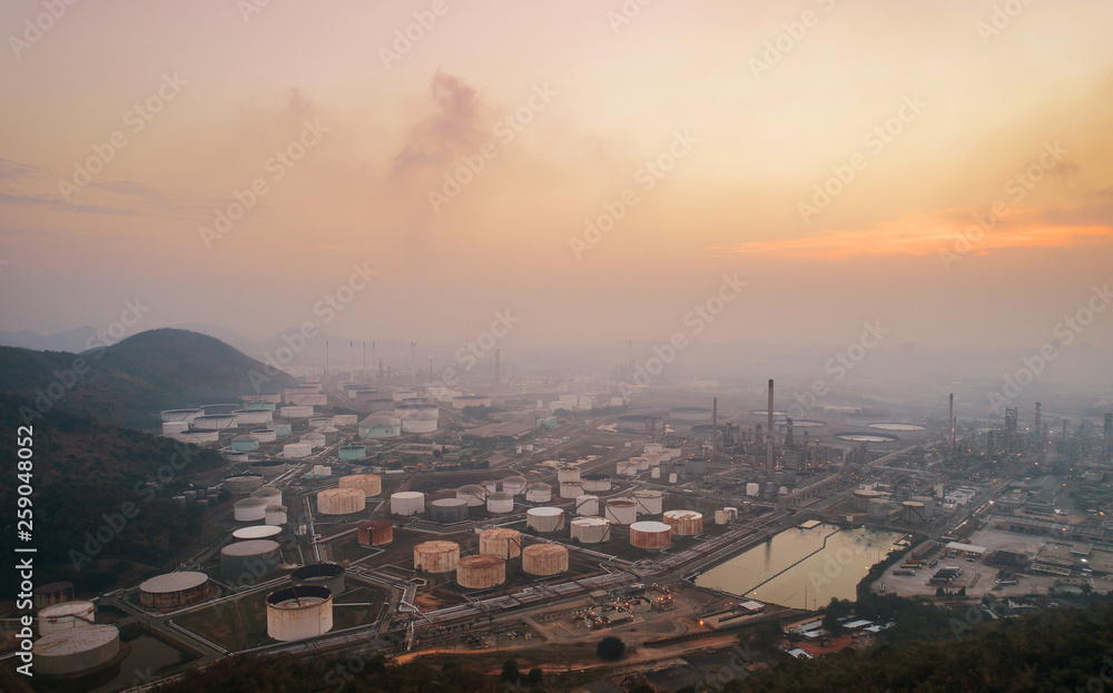 Aerial view or top view night light oil terminal is industrial facility for storage of oil and petrochemical. oil manufacturing products ready for transport and business transportation.