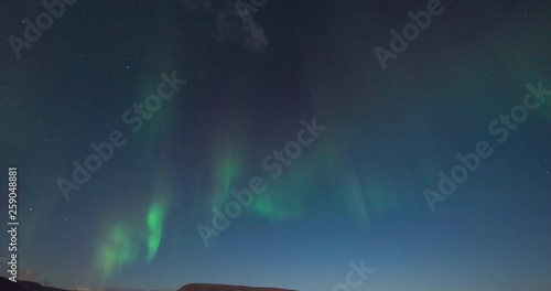 Timelapse of northern lights with beautiful landscape in view