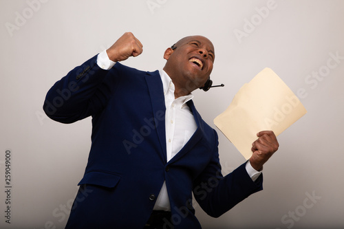 Happy African American Businessman Holds Up File