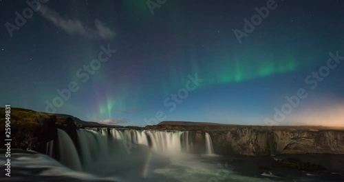 Timelapse of amazing northern lights over waterfall in Iceland
