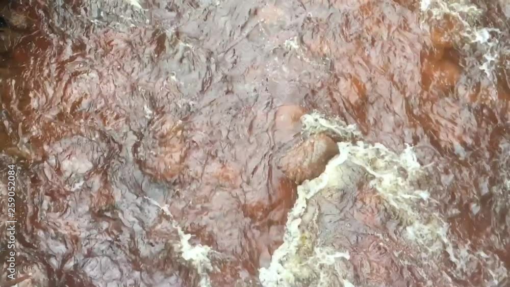 Aerial view of King river water flowing over rocks in Queenstown Tasmania, Australia. Aerial view of King river water flowing over rocks in Queenstown Tasmania, Australia.