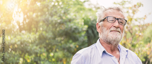 Portrait of stressful sad senior caucasian old man in the park outdoors with copy space. Spring healthcare lifestyle stress painful retirement golden age crisis concept banner