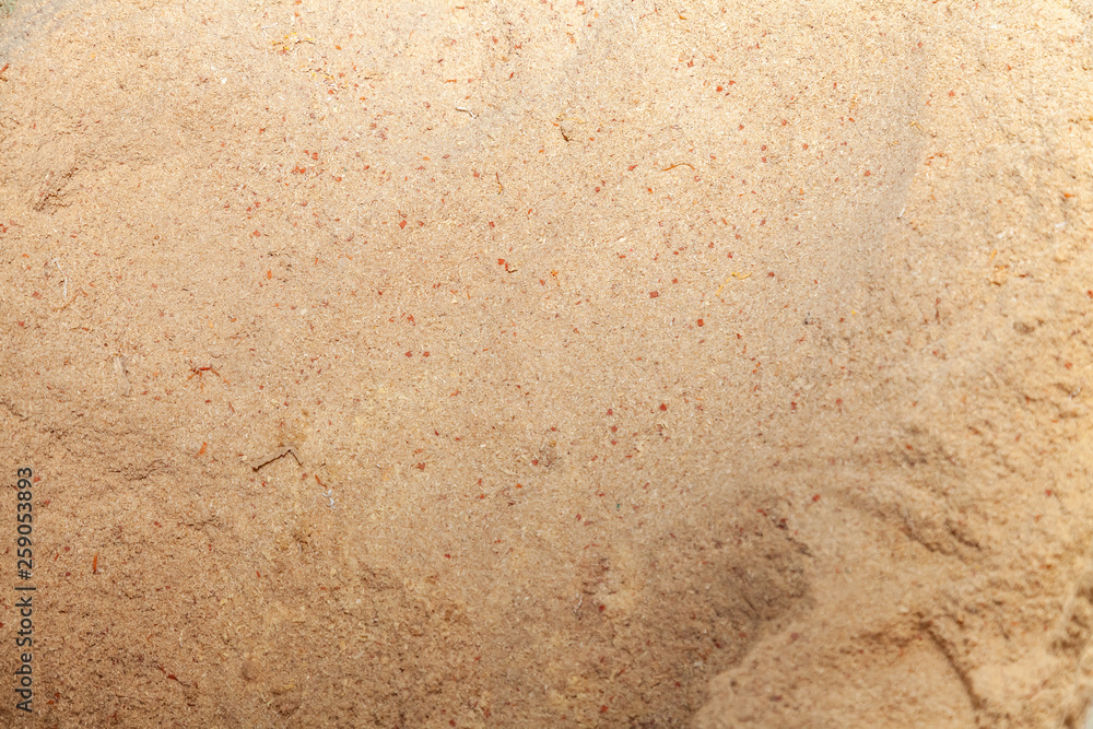 Close-up on the background and texture of yellow wooden sawdust that lie in a pile Close-up on the background and texture of yellow wooden sawdust that lie in a pile