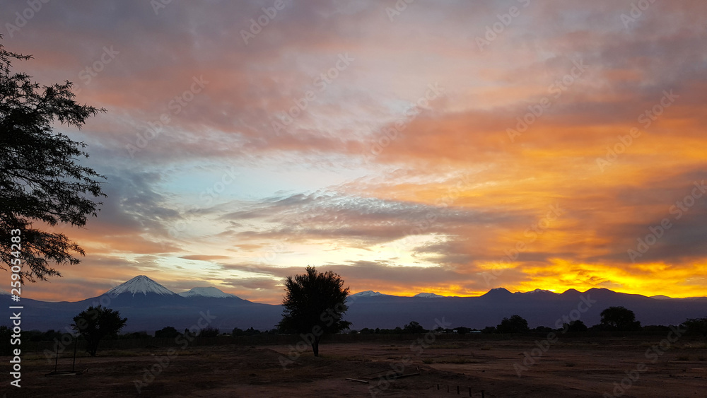 Spectacular sunrise on the volcanoes of the Andean cordillera in northern Chile, Atacama Desert, Chile