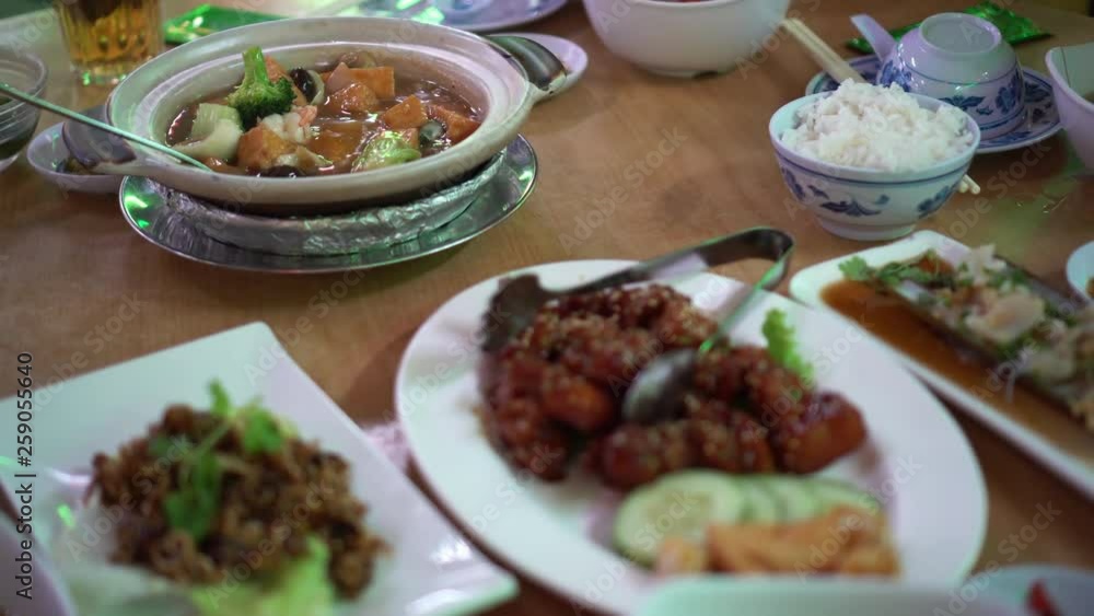 Chinese round table meal in restaurant gungpao chickend and tofu clay pot Chinese round table meal in restaurant gungpao chickend and tofu clay pot