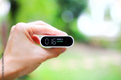 outdoor air quality measurement. pm2.5 (particulate matter) sensors detecting small dust in the atmosphere. good air with little dust in the air. park, garden and tree reduce air pollution.