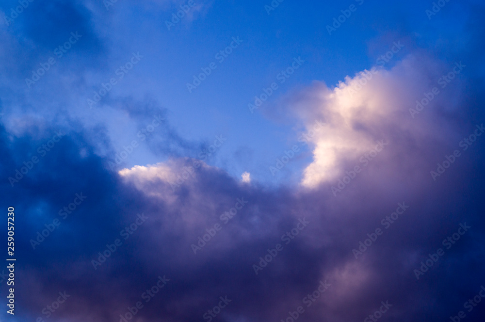 blue evening sky with white and gray clouds; cumulus. background; nature