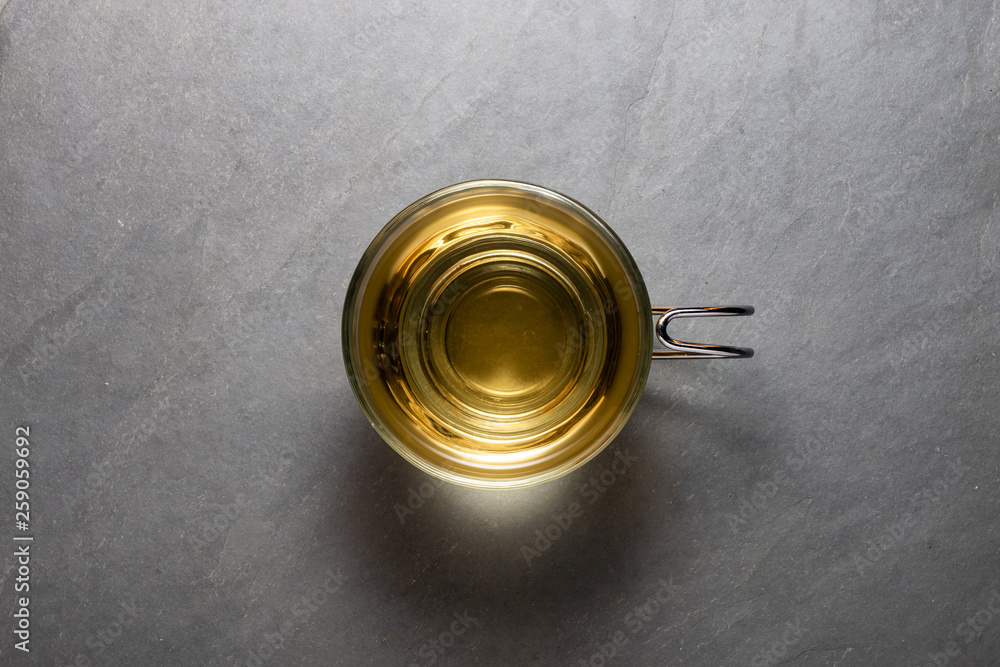 Top view photo of a mint tea cup over a stone background Top view photo of a mint tea cup over a stone background