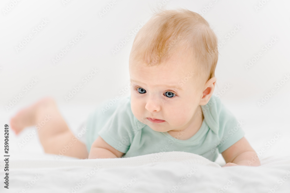 Portrait of cute newborn baby lying on belly at home Portrait of cute newborn baby lying on belly at home