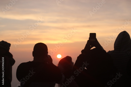 silhouette of couple at sunset © alongkorn