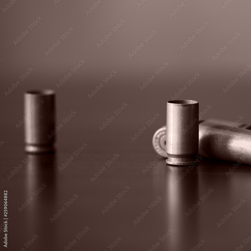Old bullet cartridges on a dark background close up. Brown color toned Old bullet cartridges on a dark background close up. Brown color toned