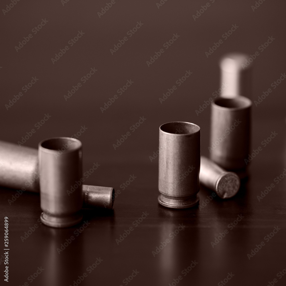 Old bullet cartridges on a dark background close up. Brown color toned