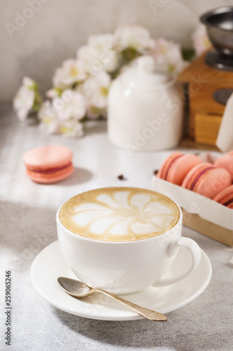 Cup of coffee and french macarons. Natural sunlight.