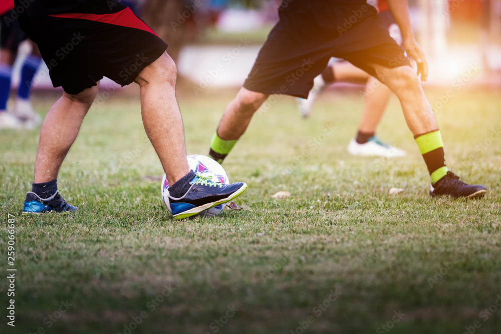 People playing soccer in public park for exercise. Football around the world concept.