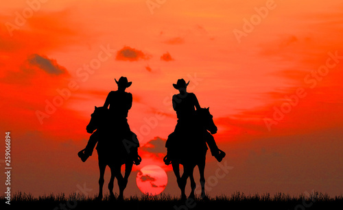 silhouette Cowboy riding a horse on sunrise