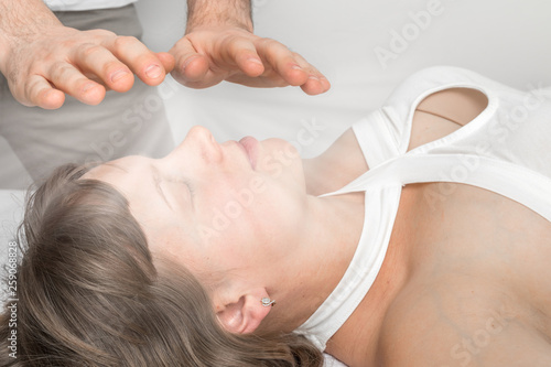 Woman is having reiki healing treatment