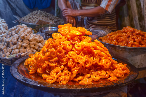 Close Up Shot Of Freshly cooked traditional Indian dessert or sweets Jalebi is selling at local market.