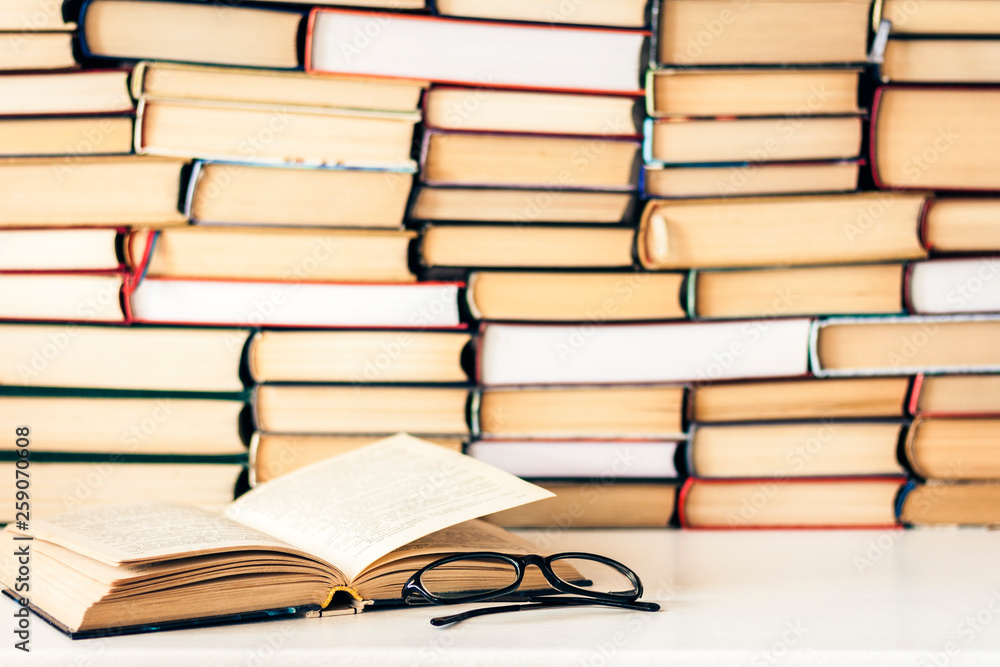Books background, open book and glasses on white wooden table in office business background for education learning concept. Books background, open book and glasses on white wooden table in office business background for education learning concept.