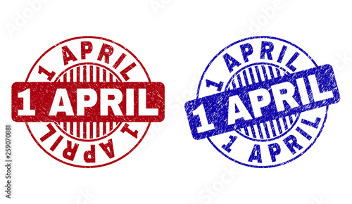 Grunge 1 APRIL round stamp seals isolated on a white background. Round seals with distress texture in red and blue colors. Vector rubber imprint of 1 APRIL label inside circle form with stripes.