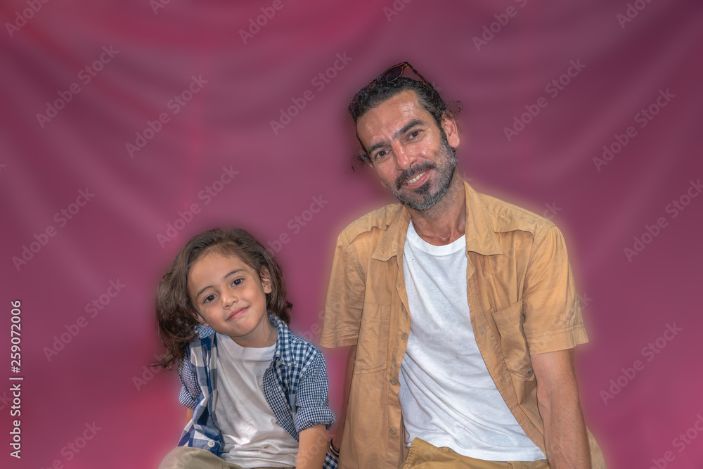 a long hair boy and his father on pink background
