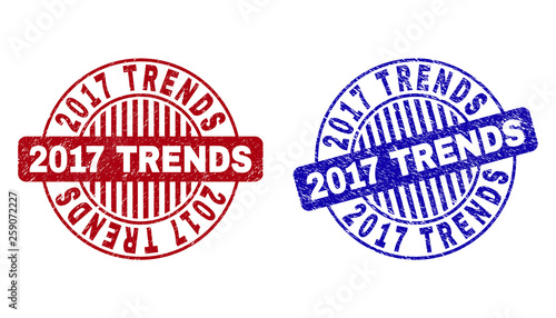 Grunge 2017 TRENDS round stamp seals isolated on a white background. Round seals with grunge texture in red and blue colors. Vector rubber imitation of 2017 TRENDS tag inside circle form with stripes.