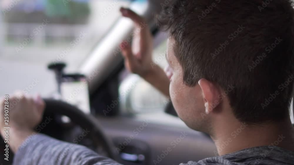 Annoyed driver in the car is angry because of traffic jam, slow motion. Annoyed driver in the car is angry because of traffic jam, slow motion.