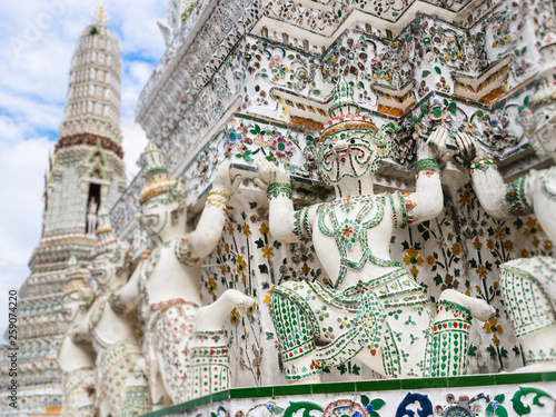 Wat Arun Colourful tiles Mosaic with Giant on Pagoda Temple Landmark Architecture Bangkok Thailand