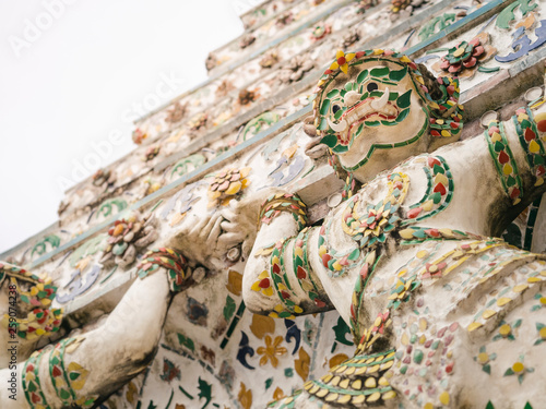 Wat Arun Colourful tiles Mosaic with Giant on Pagoda Temple Landmark Architecture Bangkok Thailand