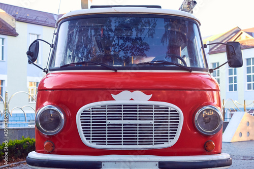 Vintage red car with white grille with white mustache