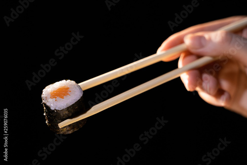 Maki sushi served on black background