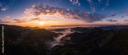 panorama over the sunrise with blue sky background at morning time and mountain fog in the winter season