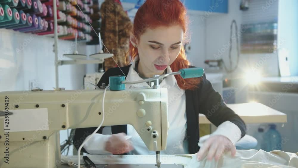 Successful tailor sewing clothes in atelier with sewing machine Successful tailor sewing clothes in atelier with sewing machine