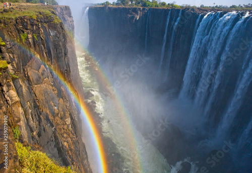 Victoria Falls. A general view with a rainbow. National park. Mosi-oa-Tunya National park. and World Heritage Site. Africa. Zambiya. Zimbabwe.  photo