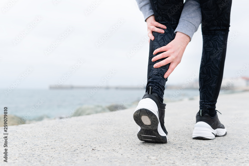 Leg muscle cramp calf sport injury outdoors exercise. Stock Photo