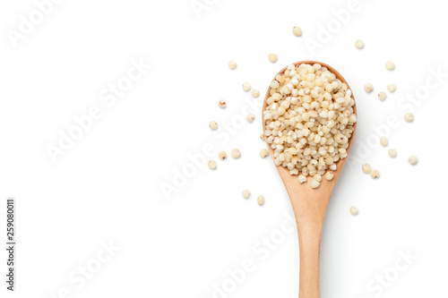 Sorghum rice in a wooden spoon isolated on white background. Top view.