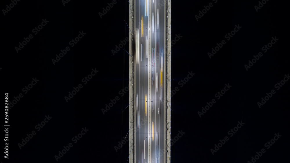 Aerial view of cars driving on bridge road at night. Long exposure photo of traffic. Transportation Icons. Aerial view of cars driving on bridge road at night. Long exposure photo of traffic. Transportation Icons.