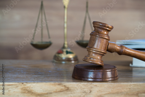 Law and justice concept image. Brown wooden background