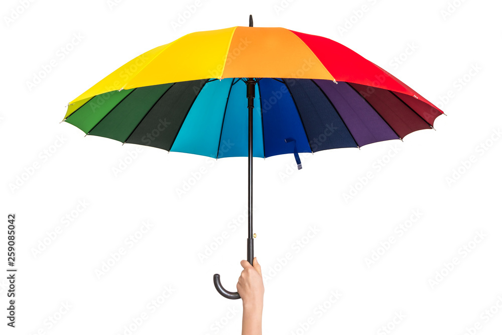 Rainbow umbrella in female hand isolated on white