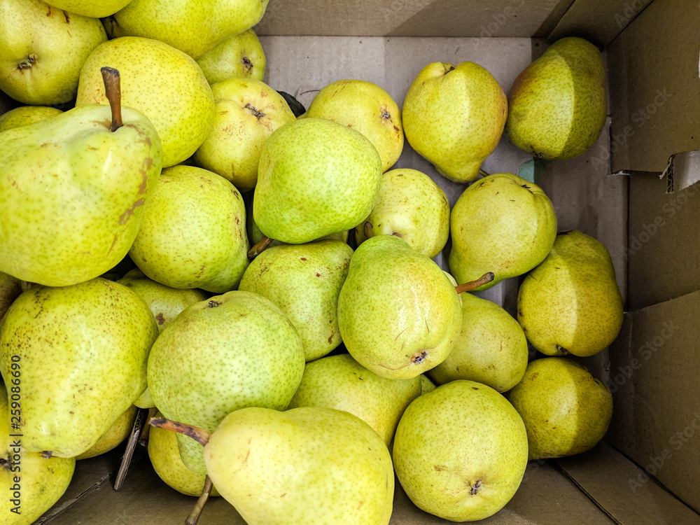 Green pear  in box, background. Fresh peares variety grown in the shop. Pear suitable for juice, strudel, pear puree, compote