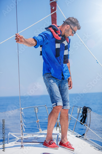Young man sailing yacht. Holidays, people, travel