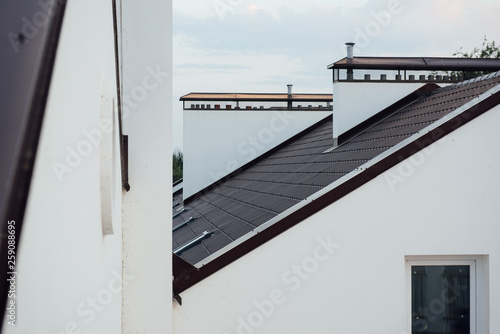 Tile Roof of a two-story white cottage