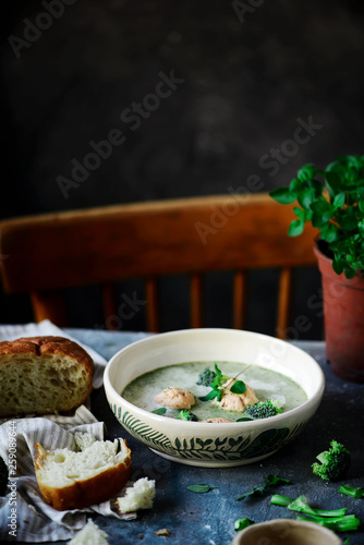 Broccoli  cream soup with salmon dumplings.selective focus photo