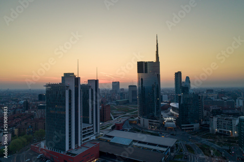 Wallpaper Mural Milan (Italy) city skyline at dawn, aerial view, flying over financial area skyscrapers in Porta Nuova district. Unicredit Tower office building at sunrise. Torontodigital.ca