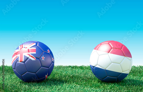 Two soccer balls in flags colors on green grass. New Zealand and Netherlands. 3d image