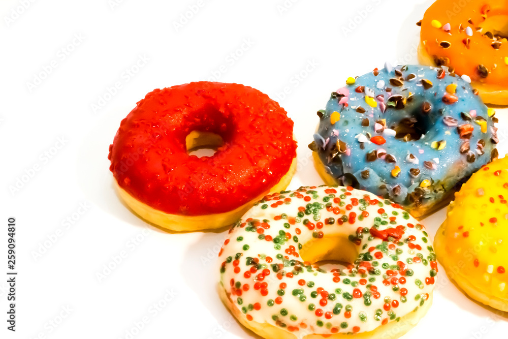 Sweet tasty donuts with colorful sprinkles isolated on white background Sweet tasty donuts with colorful sprinkles isolated on white background