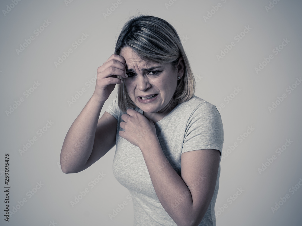 Young attractive woman looking scared, frightened and shocked. Human expressions and emotions Young attractive woman looking scared, frightened and shocked. Human expressions and emotions