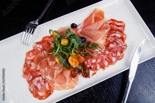 Meat slicing platter - prosciutto ham, bresaola, pancetta, salami and parmesan photo